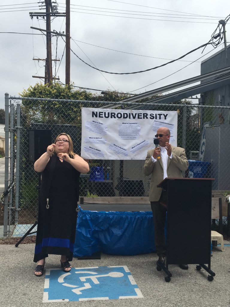 A speaker from Mayor Garcetti's office has his words translated by an ASL Interpreter.