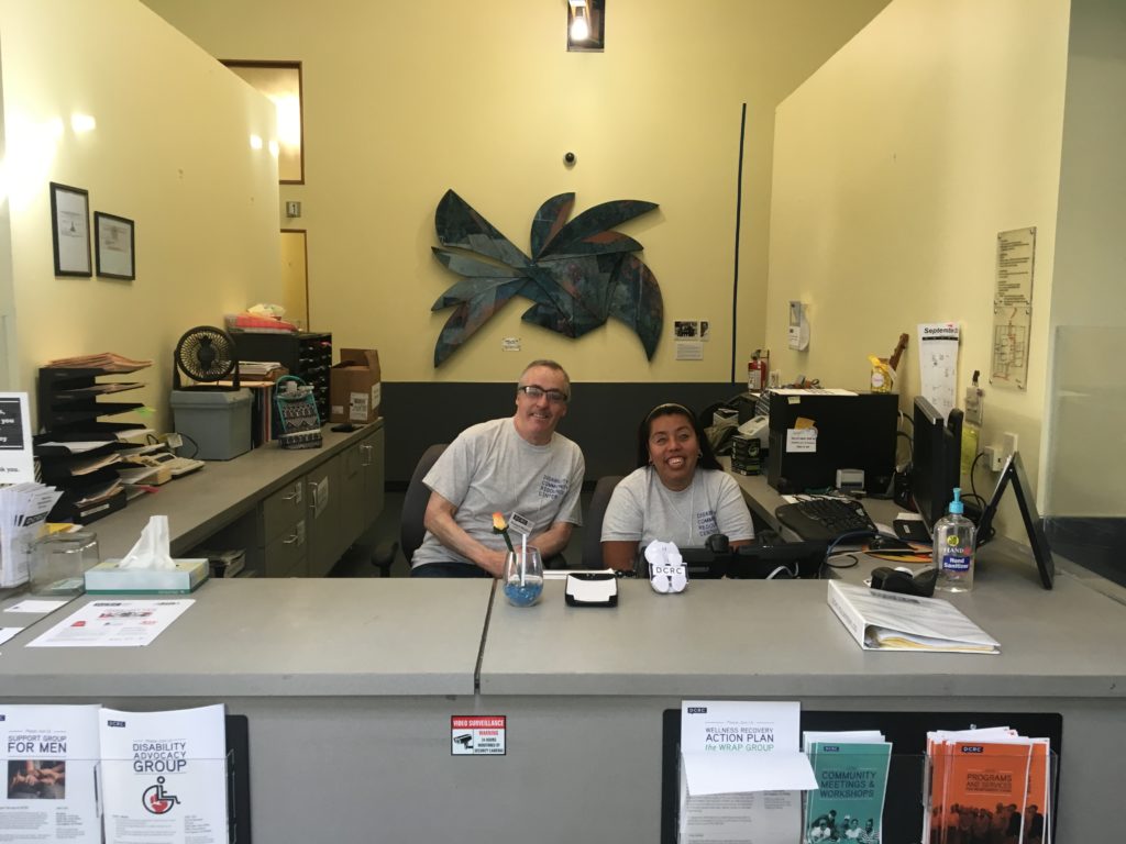DCRC staff members Richie and Nancy at the reception desk.